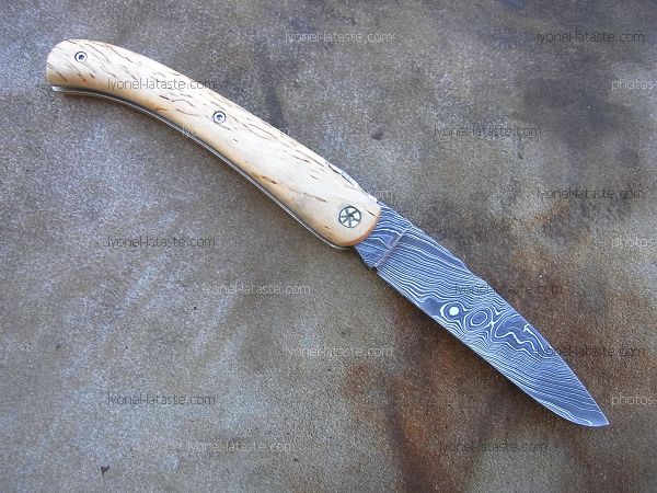 Couteau LOU PALOUMAYRE avec manche en bouleau madré et lame en damas forgé.