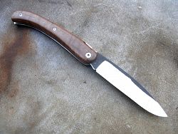 Couteau LOU PALOUMAYRE avec un manche en noyer blond, lame acier carbone xc75 finition brut de forge.  